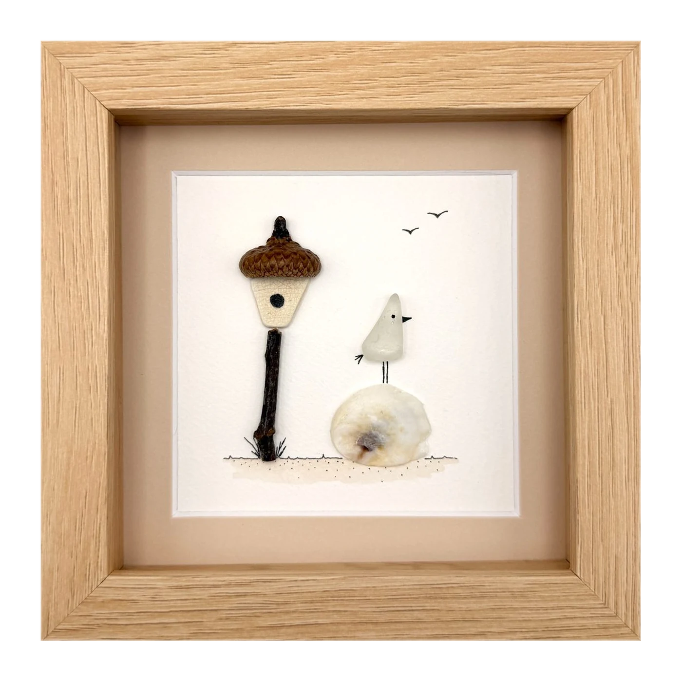 Sea glass bird beside an acorn lamp