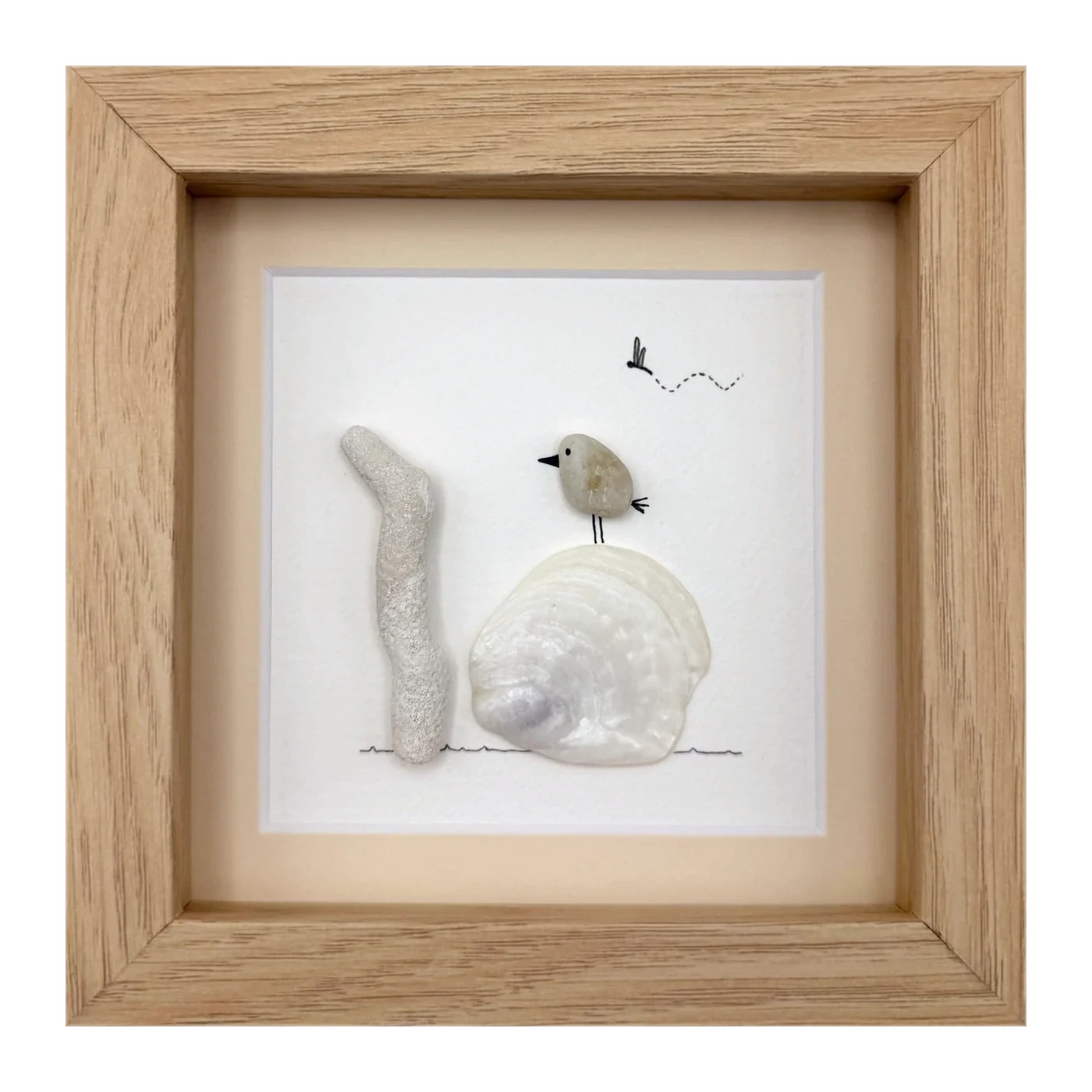 Pebble bird on a white clam shell