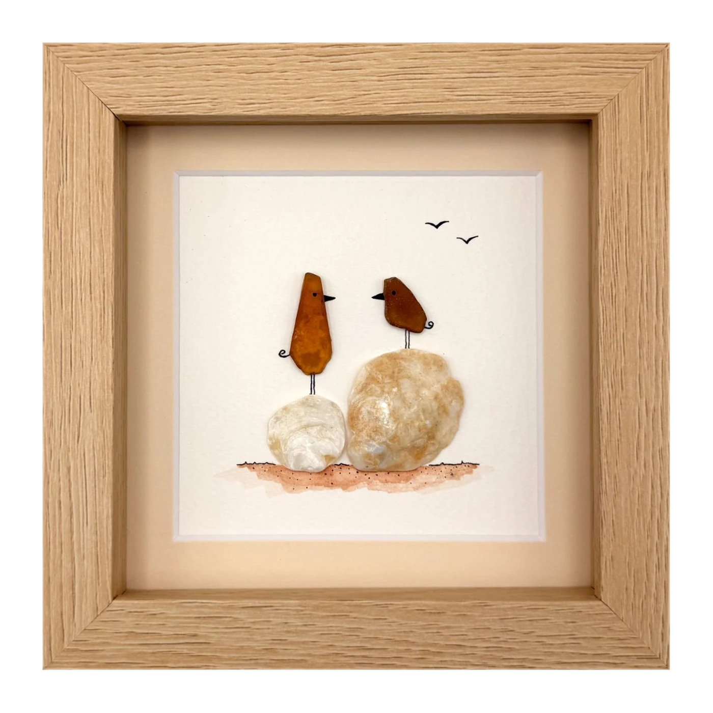 Two amber sea glass birds on shells