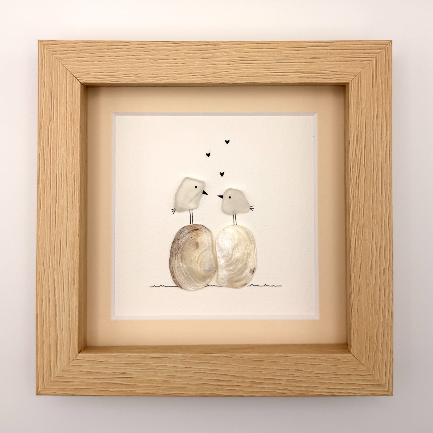 Two white birds with hearts