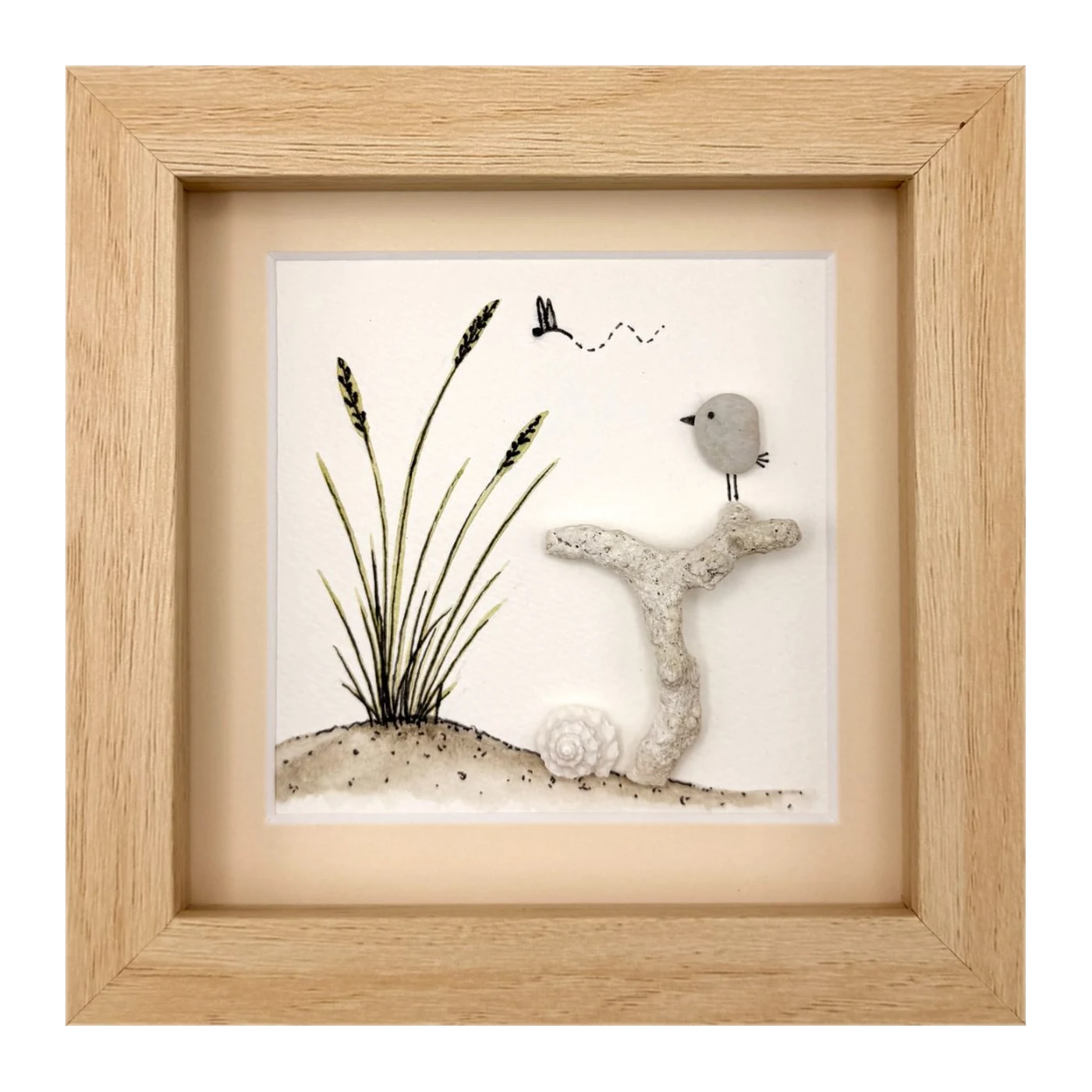 Pebble bird on coral beside dune grass