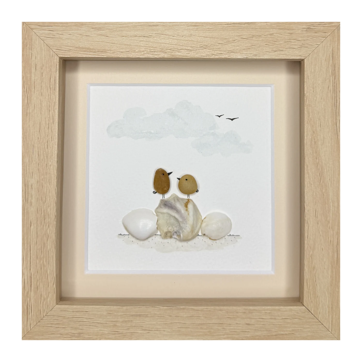 Two bronze stone birds perched on a scallop shell between two pale stones