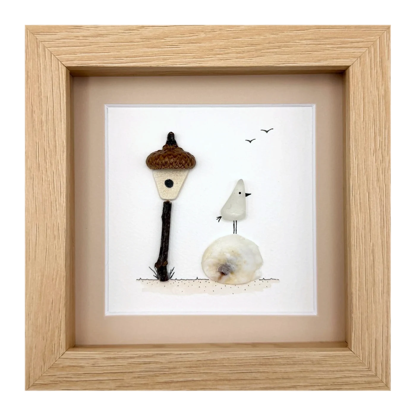 A sea glass bird beside an acorn lamp