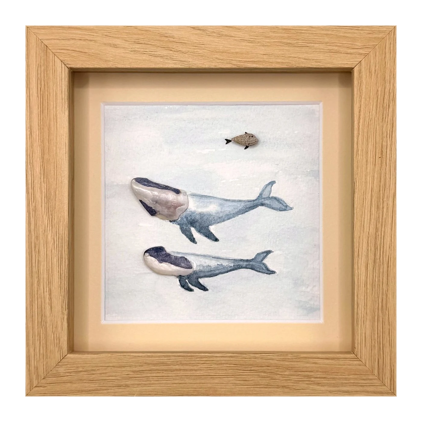 Two shell whales with a small pebble fish above them